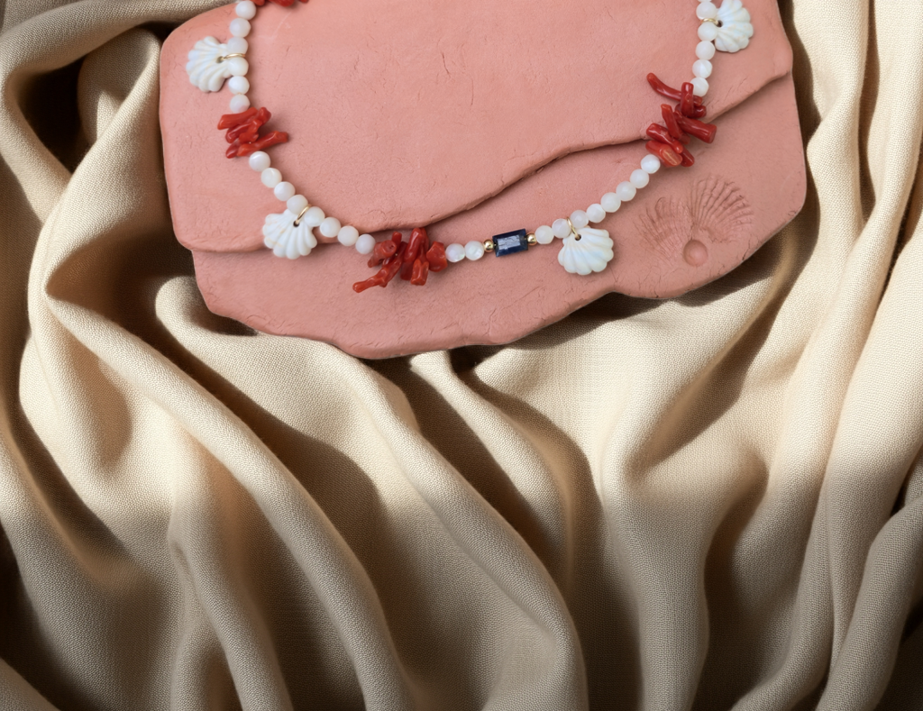Pink terracottawith a necklace on a beige fabric background